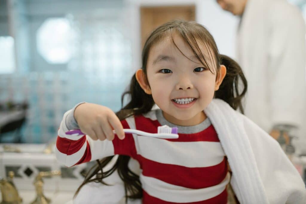 child brushing teeth